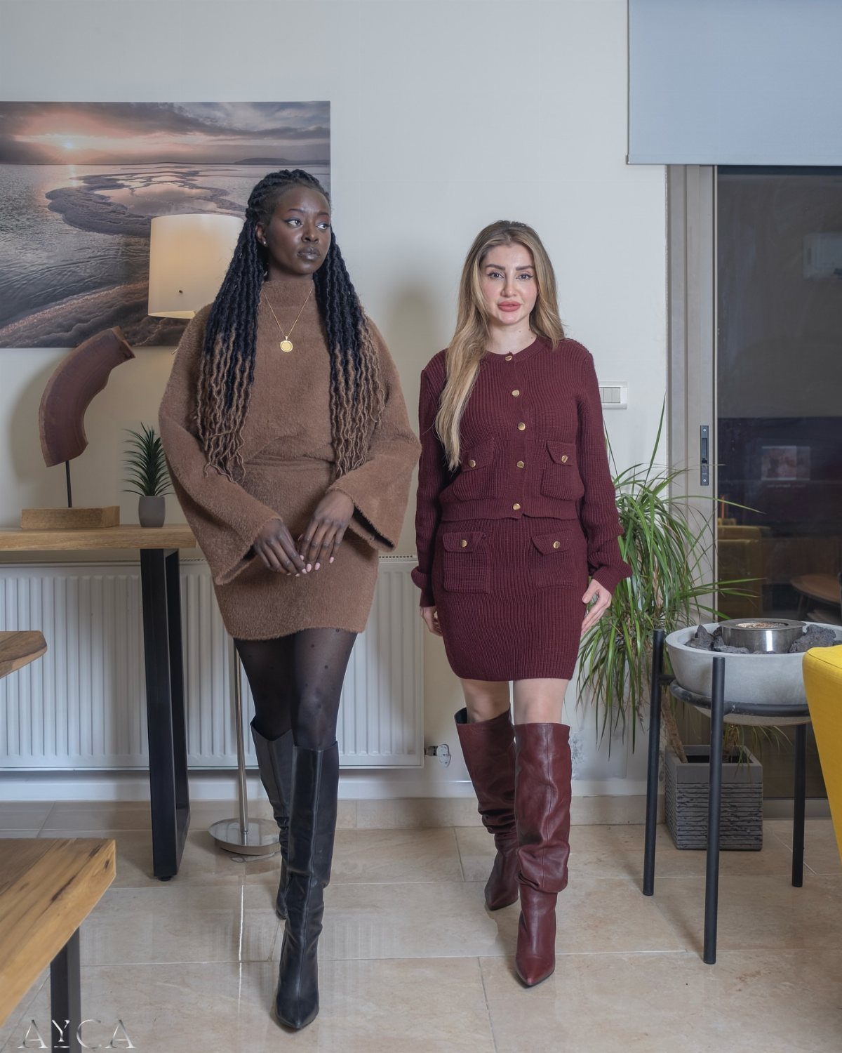 Two women wearing knit dresses paired with black and burgundy knee-high boots.